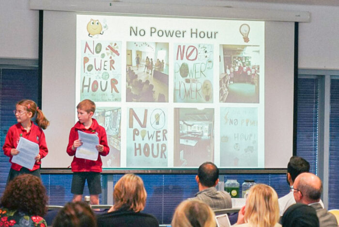 Children at a school talking about power usage